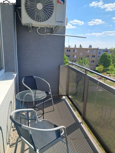 The balcony of a 2-room apartment on Považská in Senec with two chairs and a table.