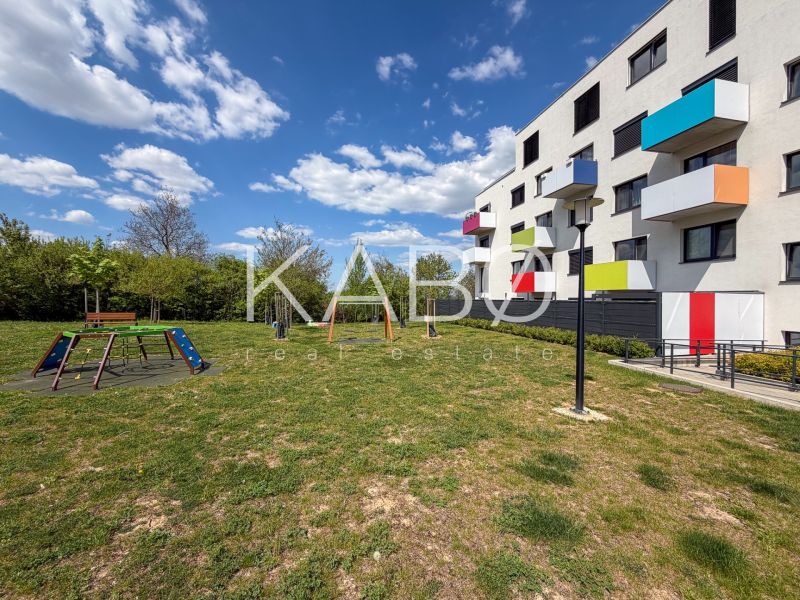 A playground in front of a colorful apartment building on Hornostavska Street in Nitra.