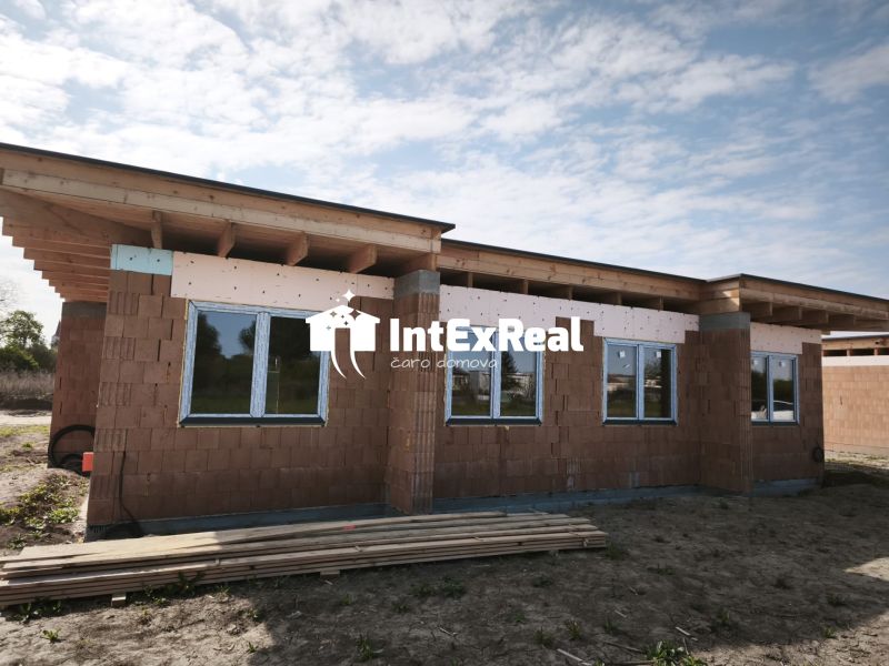 A family house on a street in Čierny Brod, in the state of rough construction with windows.