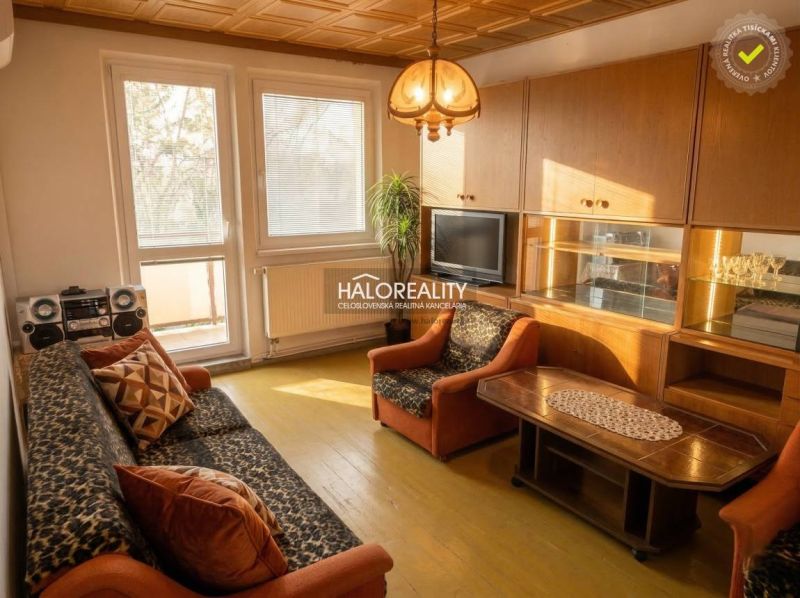 Living room in a 3-room apartment with a wooden decor floor and retro furniture.