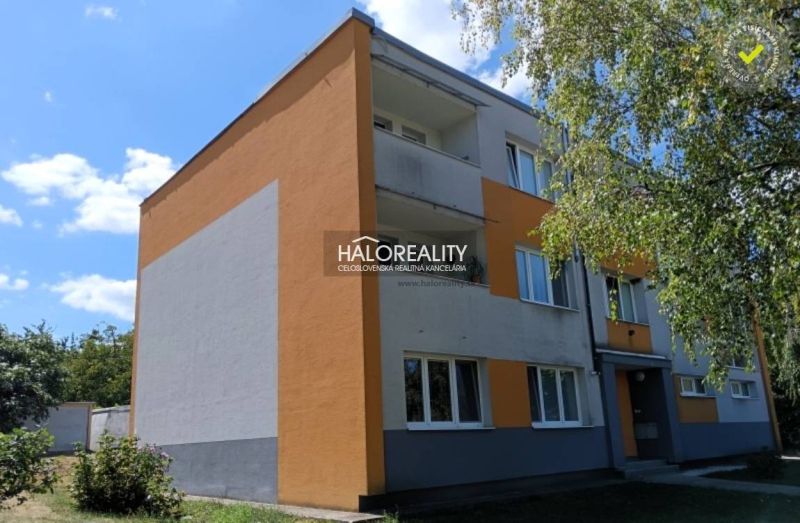 An apartment building in Smolenice offers a 3-room apartment, surrounded by greenery and blue skies.