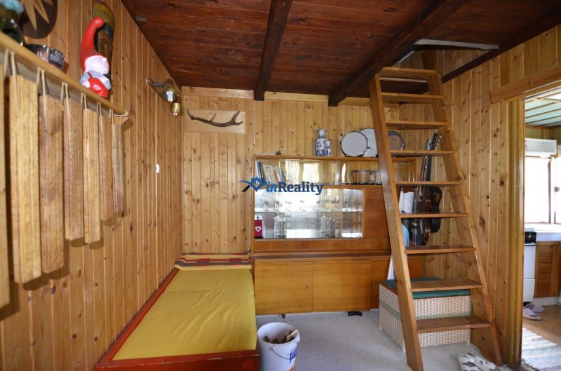 Wooden interior with a ladder, showcase, and decorations in the Garden spaces.