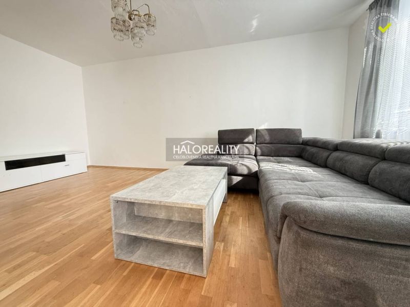 Living room in a 3-room apartment with a corner sofa and a wooden decor floor.