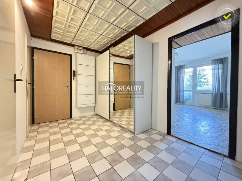 The entrance hall of a 3-room apartment with tiles and built-in cabinets.