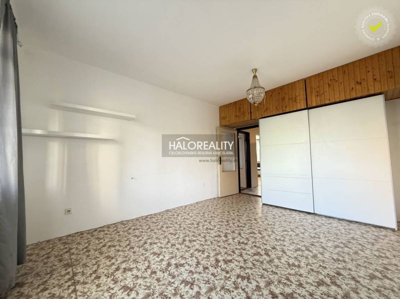 A hallway in a 3-room apartment with a built-in wardrobe and a patterned carpet.