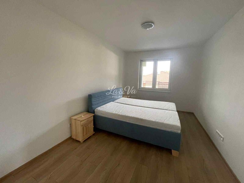 A bedroom in a family house with a bed and a wooden decor floor.