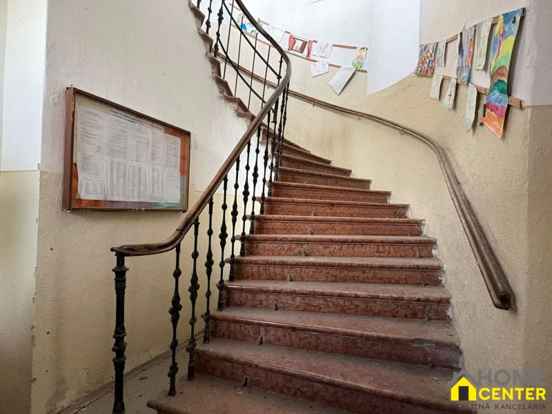 Staircase in a building of Special Properties with artworks on the walls.