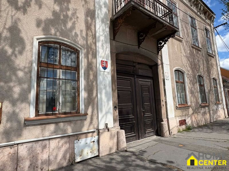 Unique properties in Komárno with historic wooden doors and windows with bars.