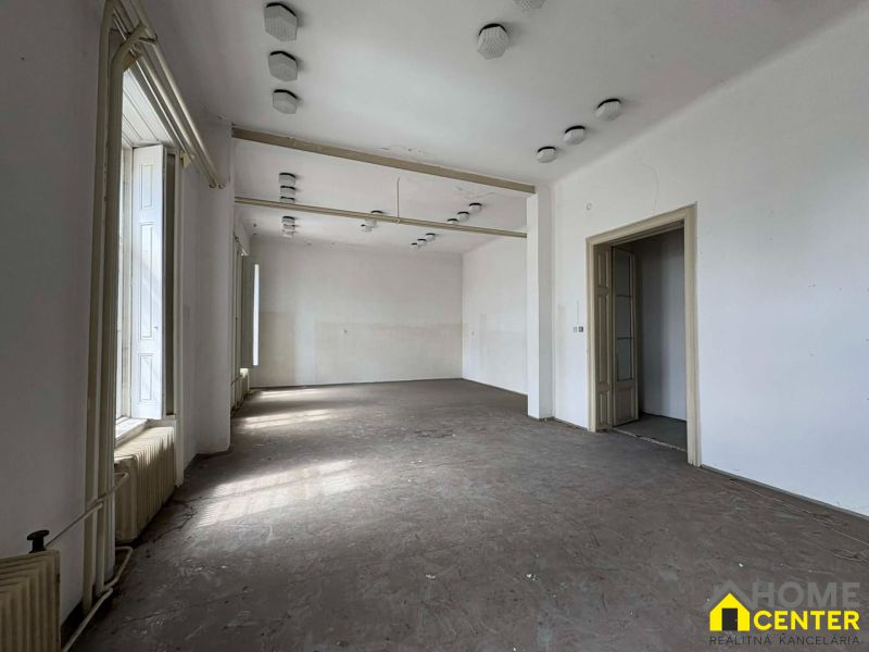 Spacious room in Special Properties with white walls and a floor with a wooden decor.