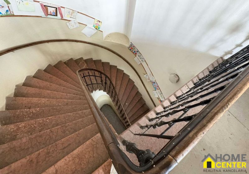 A spiral staircase with artistic decorations in Unique Properties.