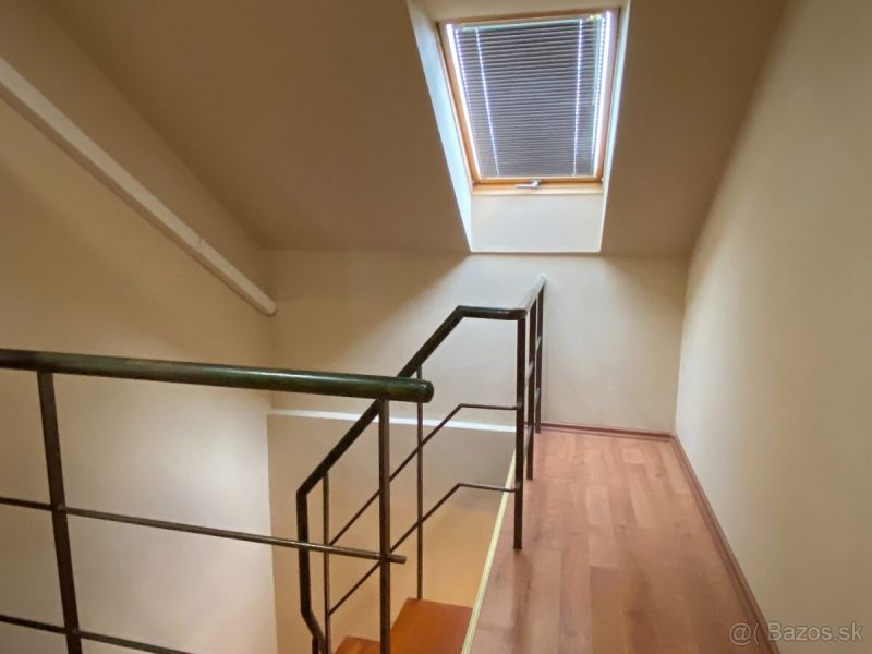 A staircase in a family house with a wooden decor floor and a skylight.