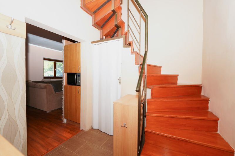 Interior of a family house with a wooden staircase and a floor with a wooden decor.