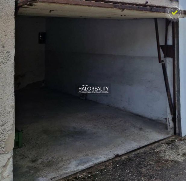 A garage in Dunajská Streda with a concrete floor and open doors.