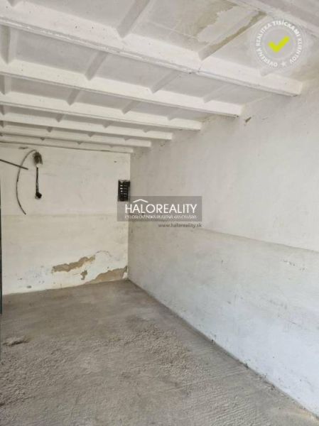 Empty garage with concrete floor and white walls.