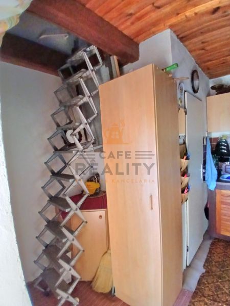 Storage spaces and stairs with wood-patterned flooring in the interior of the garden.
