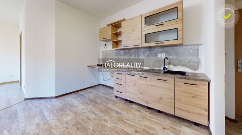 Studio apartment with a kitchenette and a wooden decor floor.