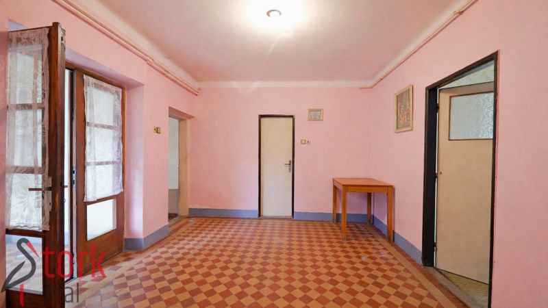 A room in a family house with pink walls and tiles.
