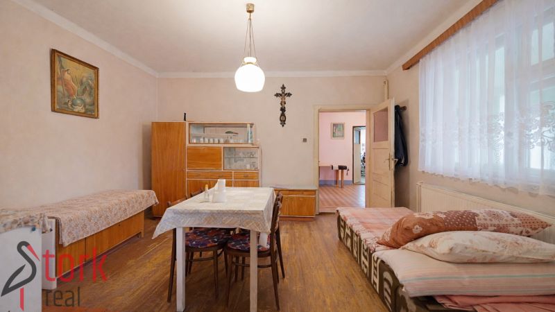 A dining room in a family house with furniture and flooring featuring a wooden decor.