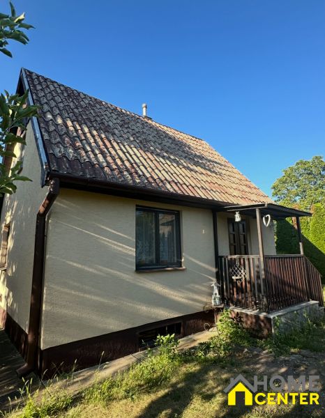 A family house with a sloped roof and a small terrace in Chotín on Pri stanici.