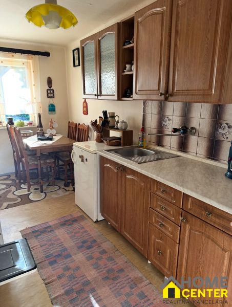 A kitchen in the Gardens with wooden decor and a dining nook.