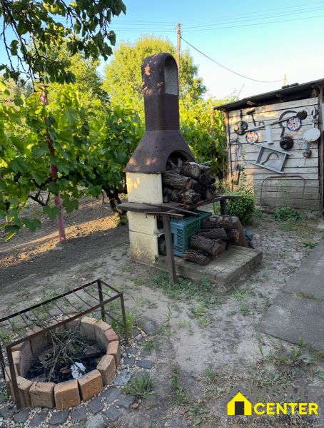 Gardens on Pri stanici Street in Chotín with an outdoor fireplace and vineyard.