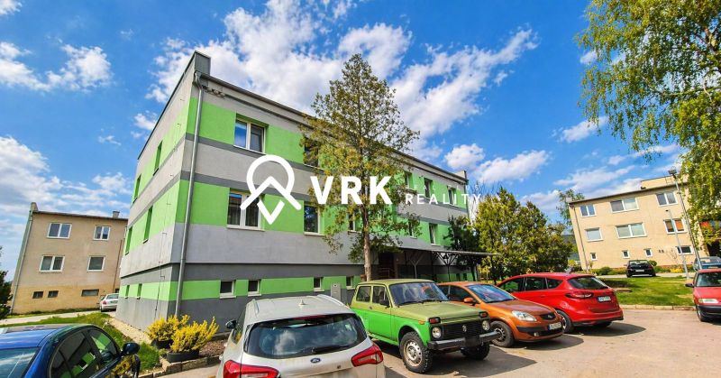 A building with a green-gray facade, parked cars on Cementár Street, Turňa nad Bodvou.