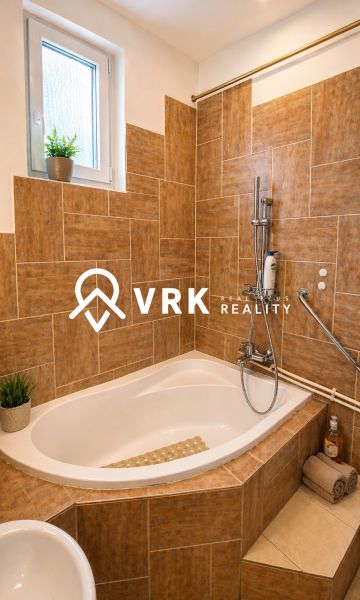A bathroom with a built-in bathtub and decorative tiles in a 4-room apartment.