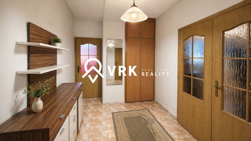Entrance hall with cabinets and wood-decor flooring in a 4-room apartment.