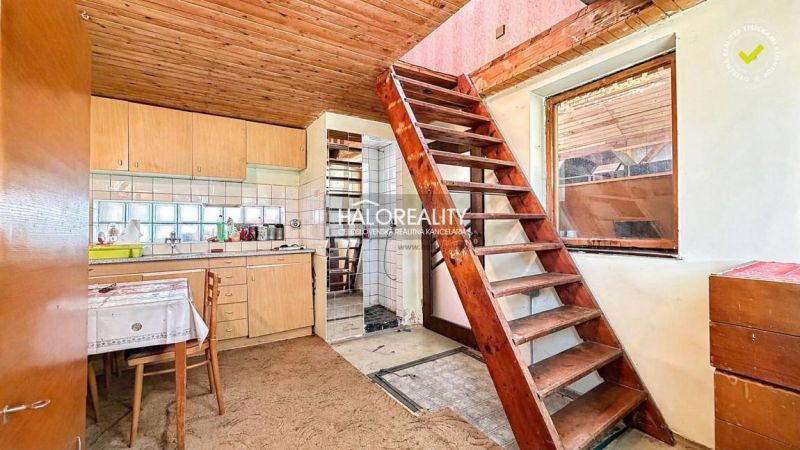 Rustic kitchen with stairs and wooden ceiling in Záhrady near Nové Zámky.