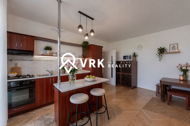 A kitchen in a 2-room apartment with a wooden decor countertop and floor.