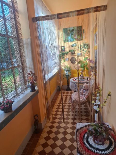 A cozy corner in a family house with curtains and a view of the garden.