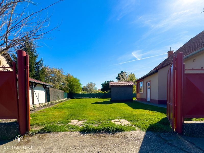 A family house in Orechová Potôň with a yard, a hedge, and a shed.