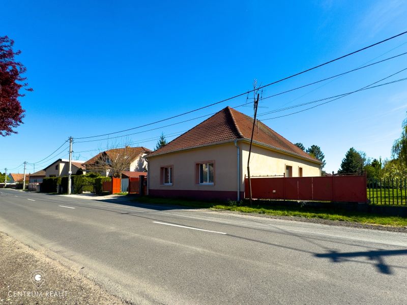 A family house in Orechová Potôň, light facade, red roof, by the road.