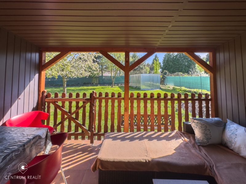A family house in Orechová Potôň with a terrace and a view of the garden with a wooden fence.