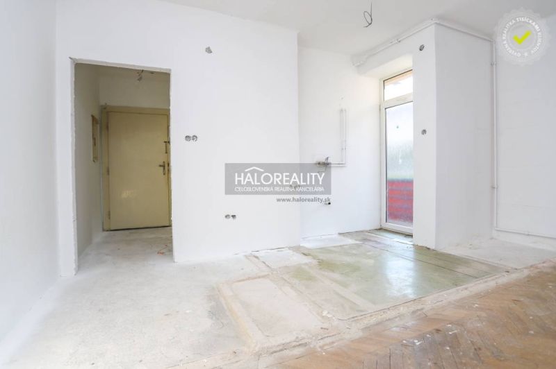 Unassigned space in a 3-room apartment with a wooden decor floor.