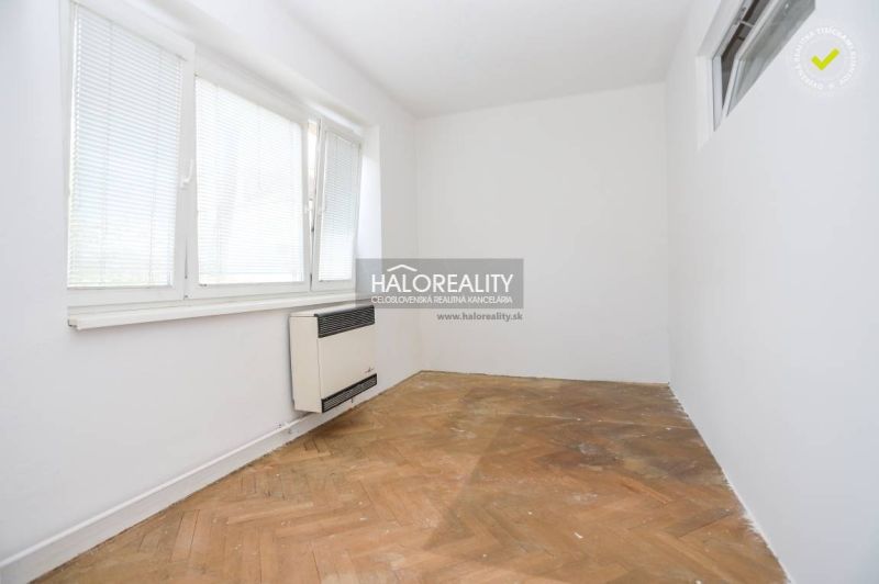 A bright room in a 3-room apartment with a wood-patterned floor, white walls.