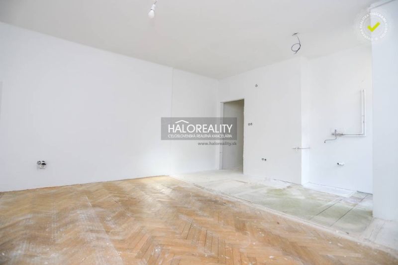 3-room apartment with wood-patterned flooring and clean white walls.
