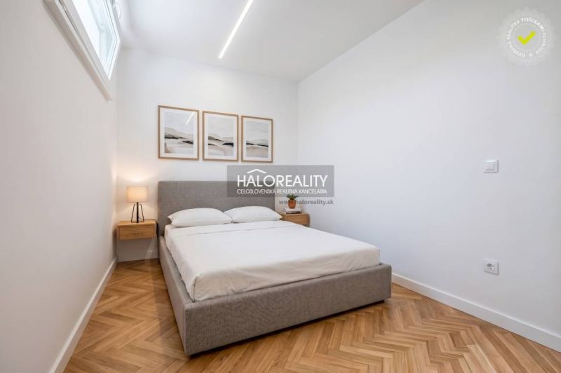 A bedroom in a three-room apartment with a wooden decor floor and cozy lighting.