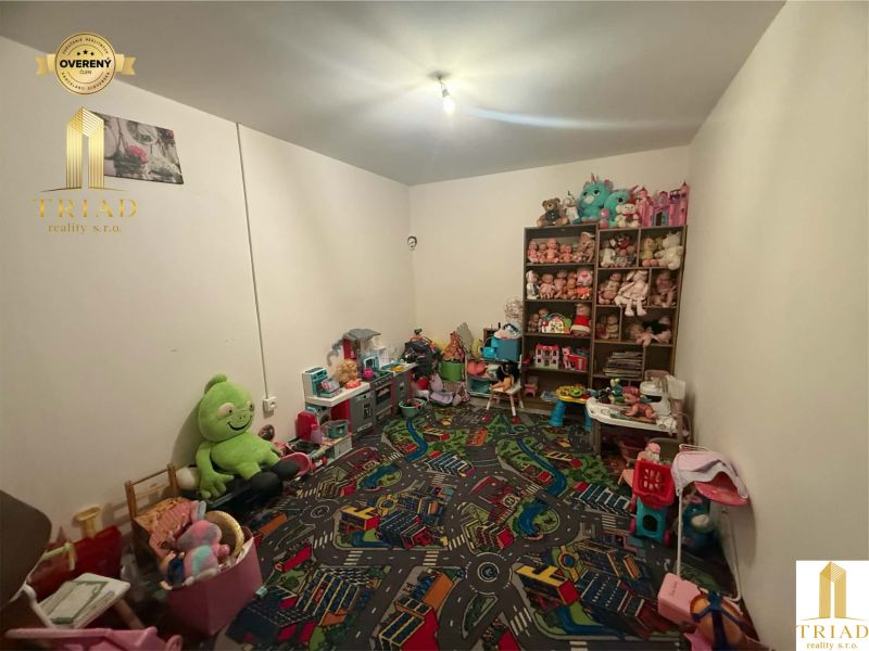 Children's room in a family house with toys and shelves full of stuffed animals.