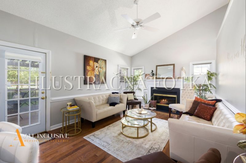 Living room in a 4-room apartment with sofas, a fireplace, and a wooden decor floor.