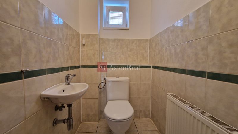 A bathroom with white sanitary ware and tiles in a family house.