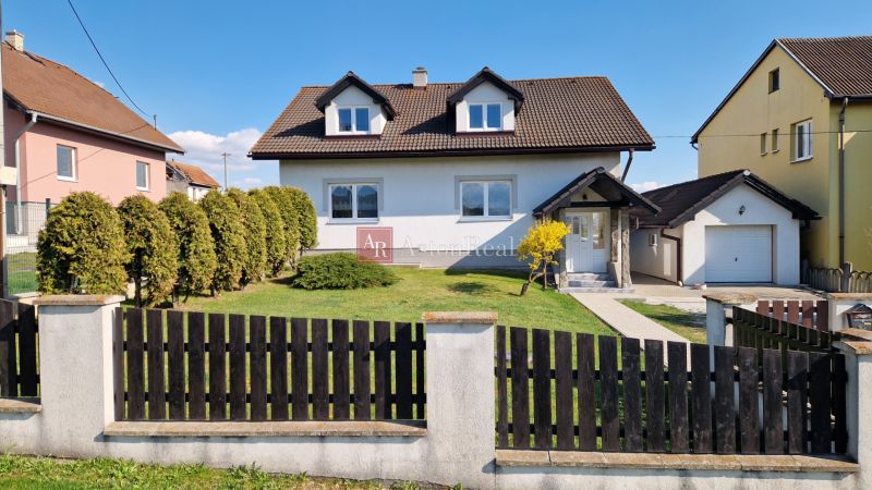 A family house in Spišský Štvrtok with a garage, garden, and landscaped exterior.