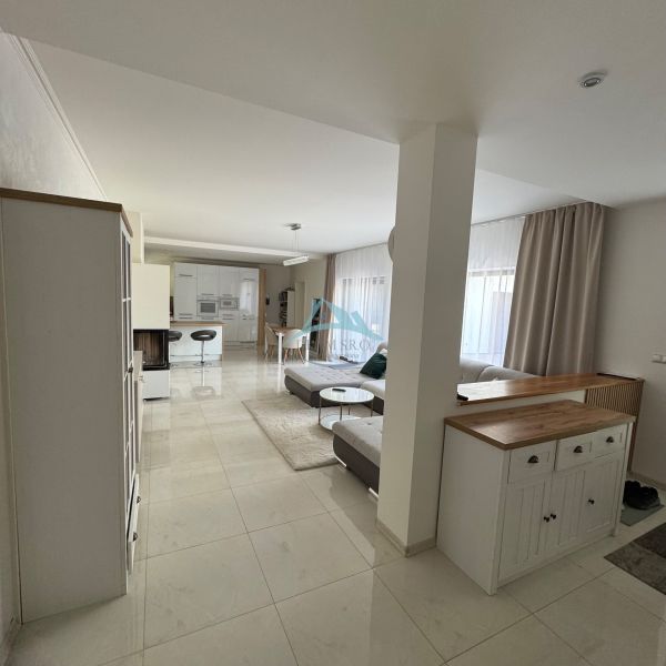 Spacious living area with kitchen and comfortable seating in a family house.