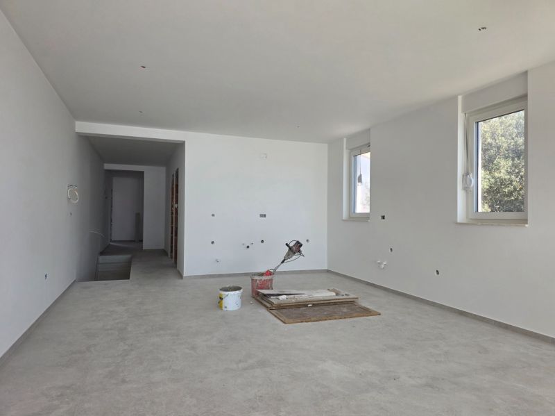 A spacious room in a 3-room apartment with large windows and a light floor.