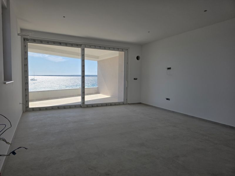 A spacious interior of a 3-room apartment with a sea view and large windows.