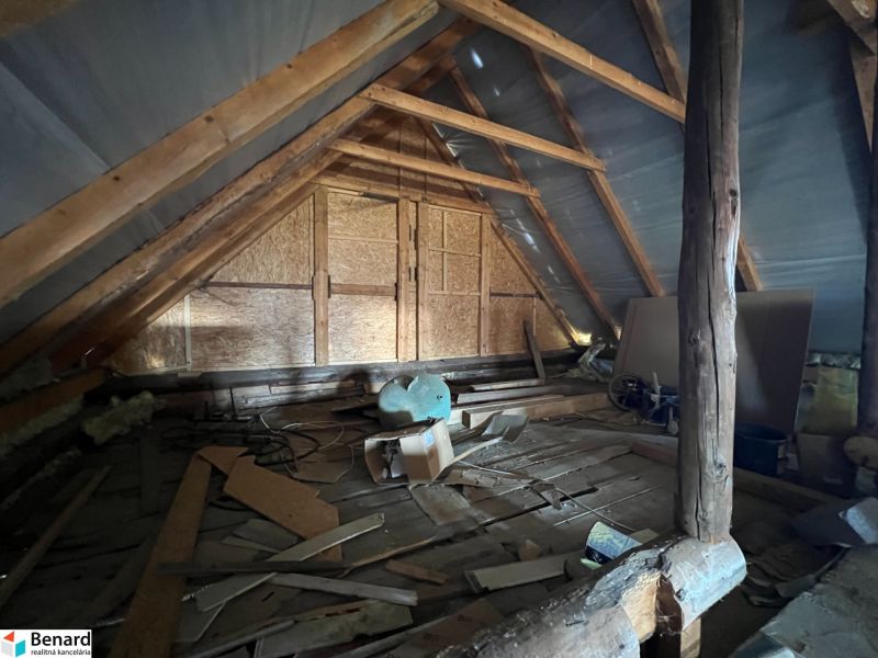 The attic of a family house with a wooden structure and various materials in Vislanka.