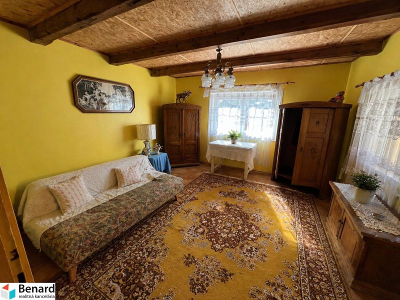 Yellow living room with carpets and rustic furniture in a family house.