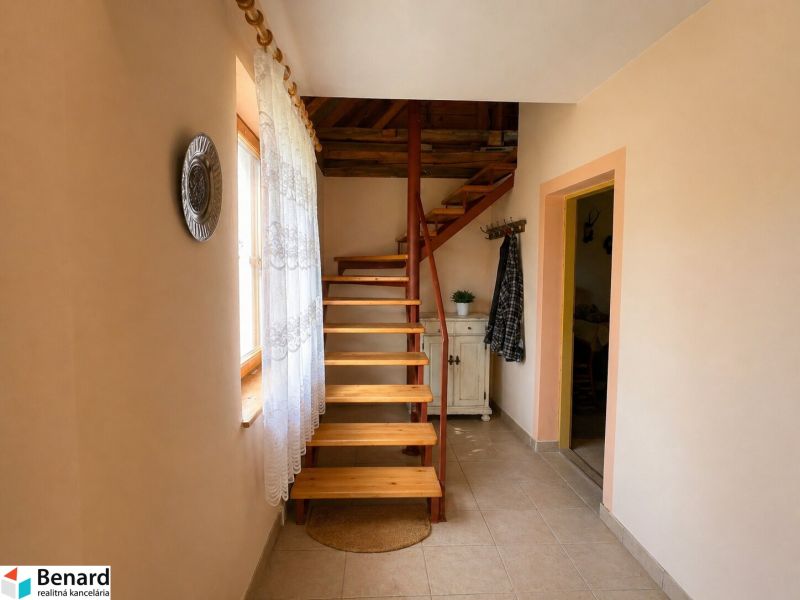 Interior of a family house with a staircase, tiles, and decorative accessories.