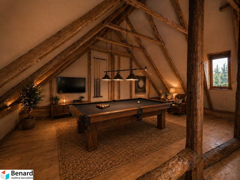 Attic room with a pool table and wood-patterned flooring in a family house.