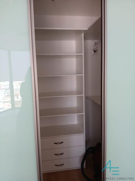 Built-in wardrobe with shelves and drawers in a 2-room apartment.